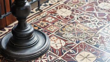 The patterned mosaic tiles on the floor in shades of cream burgundy and navy add another layer of visual interest to the vintage Victorian interior. The geometric and floral designs photo
