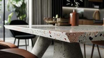The dining room table features a terrazzo top adding a pop of color and character to the otherwise simple and modern design. The mix of concrete and terrazzo creates a unique and timeless photo