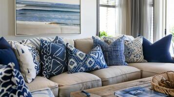 A large oversized armchair sits in the corner its light wood frame accented with plush cushions in shades of navy and ocean blue. Toss pillows with nauticalinspired patterns complete photo