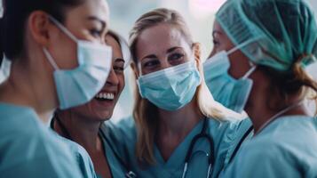 A group of nurses huddled together in conversation their masks slightly pushed aside revealing genuine smiles and animated expressions as they discuss their patients wellbeing. photo