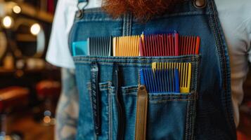 A closeup of colorful mismatched combs lined up in a barbers apron pocket emphasizing the personal touch and individuality that each barber brings to their craft through their unique photo