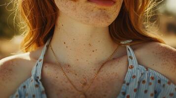 Sunspots dot her shoulders and arms like delicate polka dots adding a touch of whimsy to her summer look. photo