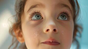 A young girl scrunches her nose in playful disbelief her eyes wide with wonder. photo
