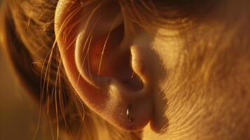 A closeup of a persons ear the s visible under the delicate skin symbolizing the ears ability to hear and process the world around us. photo