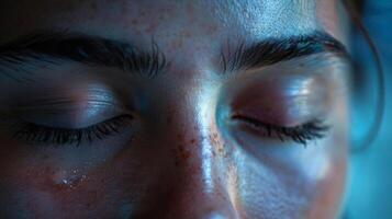 The closed eyelids seem to envelop the person in a co of mindfulness shutting off the chaos of the outside world. photo