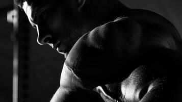 Light and shadows reveal the intricate details of his bicep showcasing the strength and definition. photo