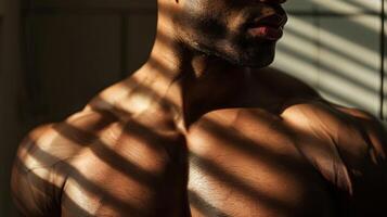 The shadows cast over the muscles of his chest add a sense of intrigue and ity to the image. photo