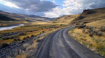 A desolate road winding its way through a serene deserted valley the only sound the gentle flow of a nearby stream. . AI generation photo