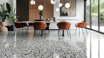 In the dining room the traditional terrazzo flooring is given a modern twist with the addition of sleek geometric patterns in a monochromatic color scheme. The fusion of old and new photo