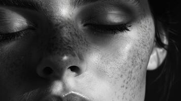 The shadows cast by the closed eyelids add depth and dimension to the face creating a somber yet beautiful image. photo