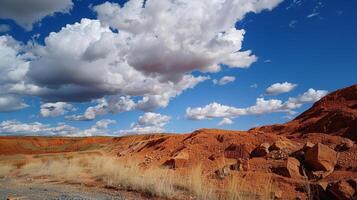 A striking contrast between the deep red bauxite ore and the bright white clouds in the sky above photo