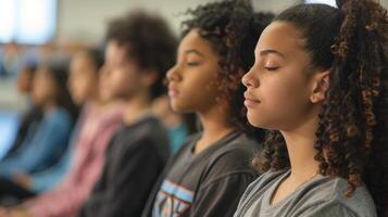 A group of students sitting in a classroom actively listening to their teachers lecture and engaging in mindful communication photo