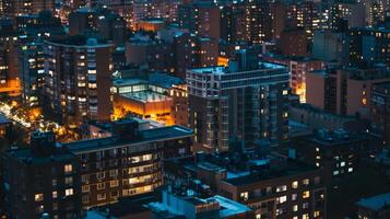 A rooftop view of a city during a blackout with several portable gas generators providing light and power in the surrounding buildings photo