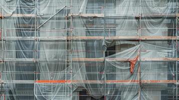 Scaffolding and tarps cover the faces of buildings concealing the transformation taking place within photo