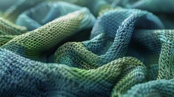 A closeup of a knitted scarf showcasing its soft texture and the complex stitch pattern in shades of blue and green photo