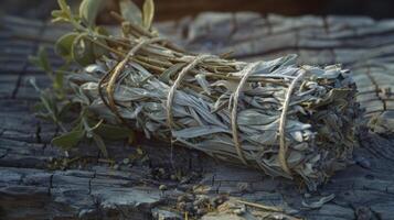 A bundle of sage tied with twine and ready to be used for cleansing and purifying in traditional medicine practices photo