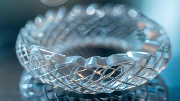 A closeup image of a small circular device with delicate interwoven threads of varying thicknesses. This highly advanced acoustic metamaterial is able to manipulate soun photo