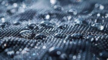A closeup of a hydrophobic coating on a piece of fabric highlighting the intricate network of tiny bumps and ridges that create a rough waterrepellent surface photo