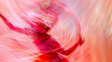 A spiraling column of vibrant red and pink moves in unison with the dancers body creating an otherworldly illusion of fluid motion photo