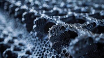 An upclose image of an aerographite panel highlighting its high density and impressive strength. The panel appears to be supporting a heavy load alluding to the material photo