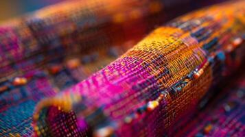A closeup of a colorful textured textile with tiny electronic components woven into the fabric. These elements transform the fabric into a touchsensitive surface allowin photo