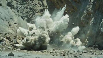 The sound of loud explosions can be heard as workers use dynamite to blast through rock photo