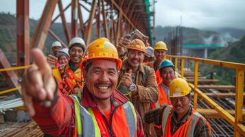With a beaming smile a group of construction workers pose for a selfie in front of a completed section of a bridge project commemorating their teamwork and accomplishment photo