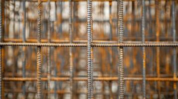 A construction site filled with vertical and horizontal rebar rods creating a mazelike structure photo