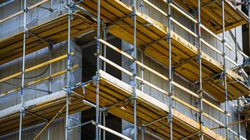 Wooden scaffolding surrounds the exterior of the hub providing support for workers as they continue to build upwards photo