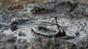 A closeup of bubbles popping on the surface of a mud pot releasing a sulfurous smell photo