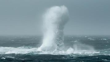 An impressive display of natures power as a water spout forms seemingly devouring the oceans surface photo