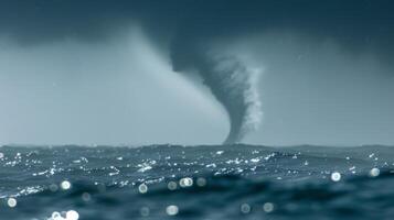 Natures version of a skyscr as a colossal water spout stands tall above a seemingly infinite ocean photo