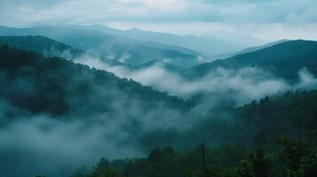 A view from above as the fog descends upon the peaks of the mountains photo