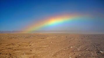 A beautiful mirage of a rainbow arcing over the desert its reflection stretching across the scorched earth photo