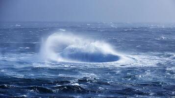 A swirling funnel of saler defying gravity over the open ocean photo