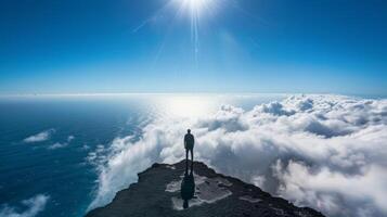 A solitary figure standing at the edge of the world their shadow taking on a life of its own in the clouds photo
