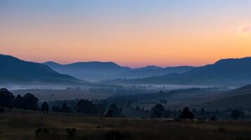 An eerie but beautiful sight of a mountain shadow stretching across a valley at dawn photo