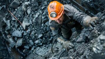 A worker using specialized equipment to measure the quality and composition of the coal being extracted photo