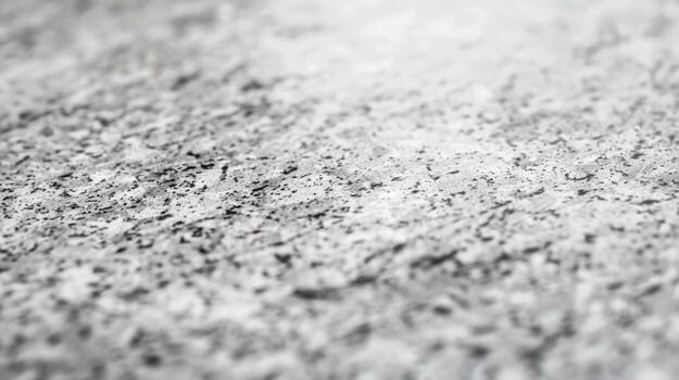 A smooth and reflective surface of a light grey granite countertop highlighting the subtle variations in color and texture photo