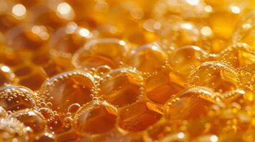 An intricate network of tiny bubbles ped within the sticky surface of honey and creating a velvety appearance photo