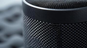 The front panel of the speaker boasts a ribbed texture almost resembling a woven fabric bringing a touch of elegance to the sleek device photo