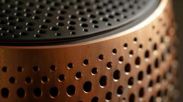 The top of the speaker displays an intricate honeycomblike design with small circular openings that create a tactile feel photo
