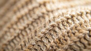 A closeup of a woven woolen hat with a ribbed texture showcasing the thickness and durability of the fabric perfect for protecting against cold weather photo