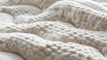 Soft fibers interweave to create a cushioned quilted fabric that is both tactile and visually appealing photo