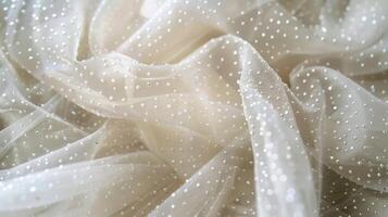 Luxurious silk tulle with tiny pearl beads tered across the surface giving off a subtle shimmer and opulent touch photo