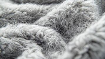 A macro shot of a grey sherpa fleece revealing individual wispy strands that create a soft dense texture photo