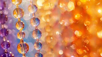 A closeup of a glass bead reveals a gradient of colors ranging from vibrant oranges and yellows to deep purples and blues. Each bead catches the light in its own way resulting in photo