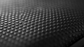 The texture of a smooth rubberized material that resembles the protective cover on a lithiumion battery providing a sy and comfortable grip photo