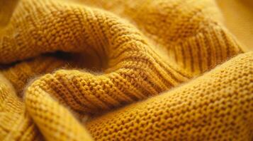 A closeup of a soft stretchy knit fabric in a cheerful mustard yellow color perfect for adding a pop of color to a cozy winter outfit photo