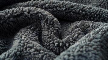 A detailed shot of dark grey Sherpa lining showcasing its dense and plush composition photo